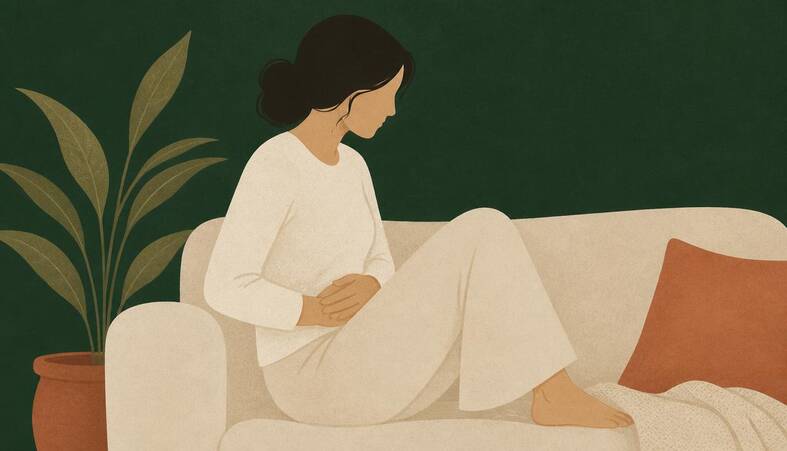 Illustration of a person seated on a sofa with both hands resting on the lower abdomen